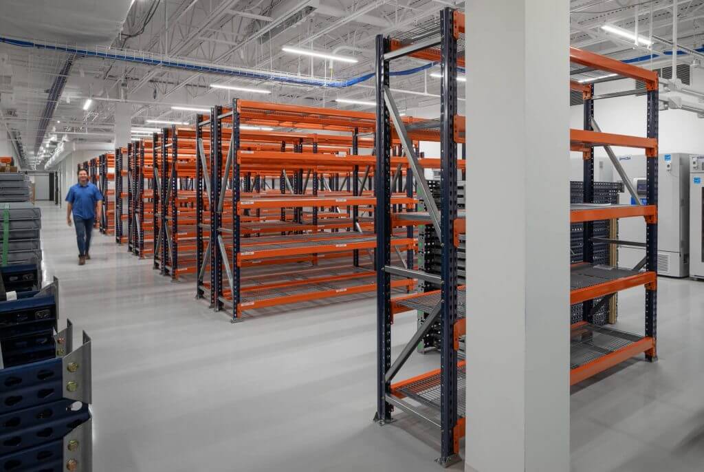 Storage area at Cellipont’s GMP manufacturing facility, featuring organized pallet racking systems for material management and bioproduction logistics.
