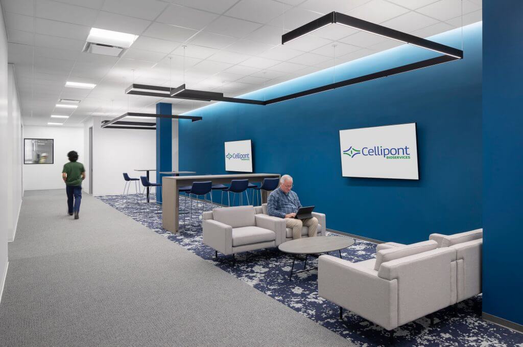 Cellipont Bioservices employee lounge and collaboration space featuring modern seating, branded displays, and a welcoming environment within the GMP manufacturing facility.