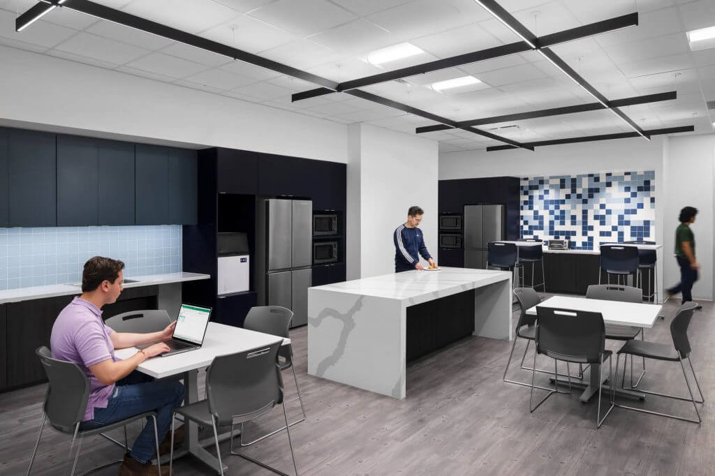 Team members using Cellipont’s employee breakroom, featuring full kitchen amenities and collaborative space within the GMP biomanufacturing facility.