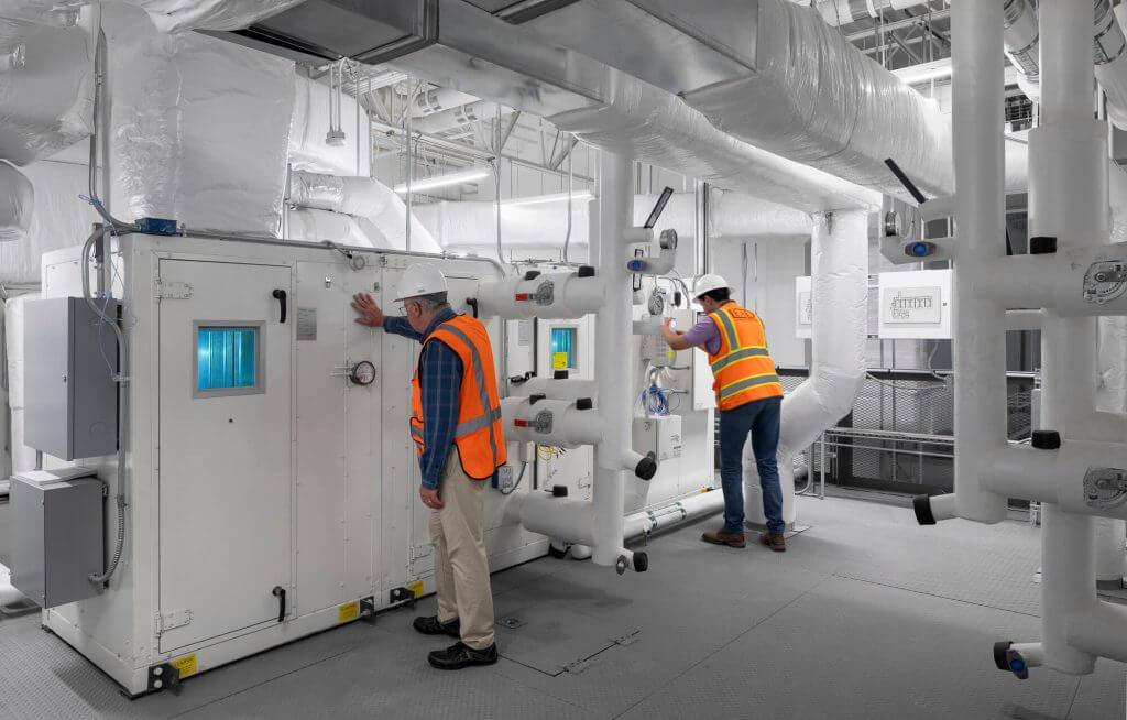 Engineers inspecting HVAC and mechanical systems in Cellipont’s GMP facility, ensuring critical cleanroom climate control and utility infrastructure for cell therapy manufacturing.